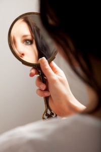 Closeup of a mirror reflection of a woman's eye, selective focus